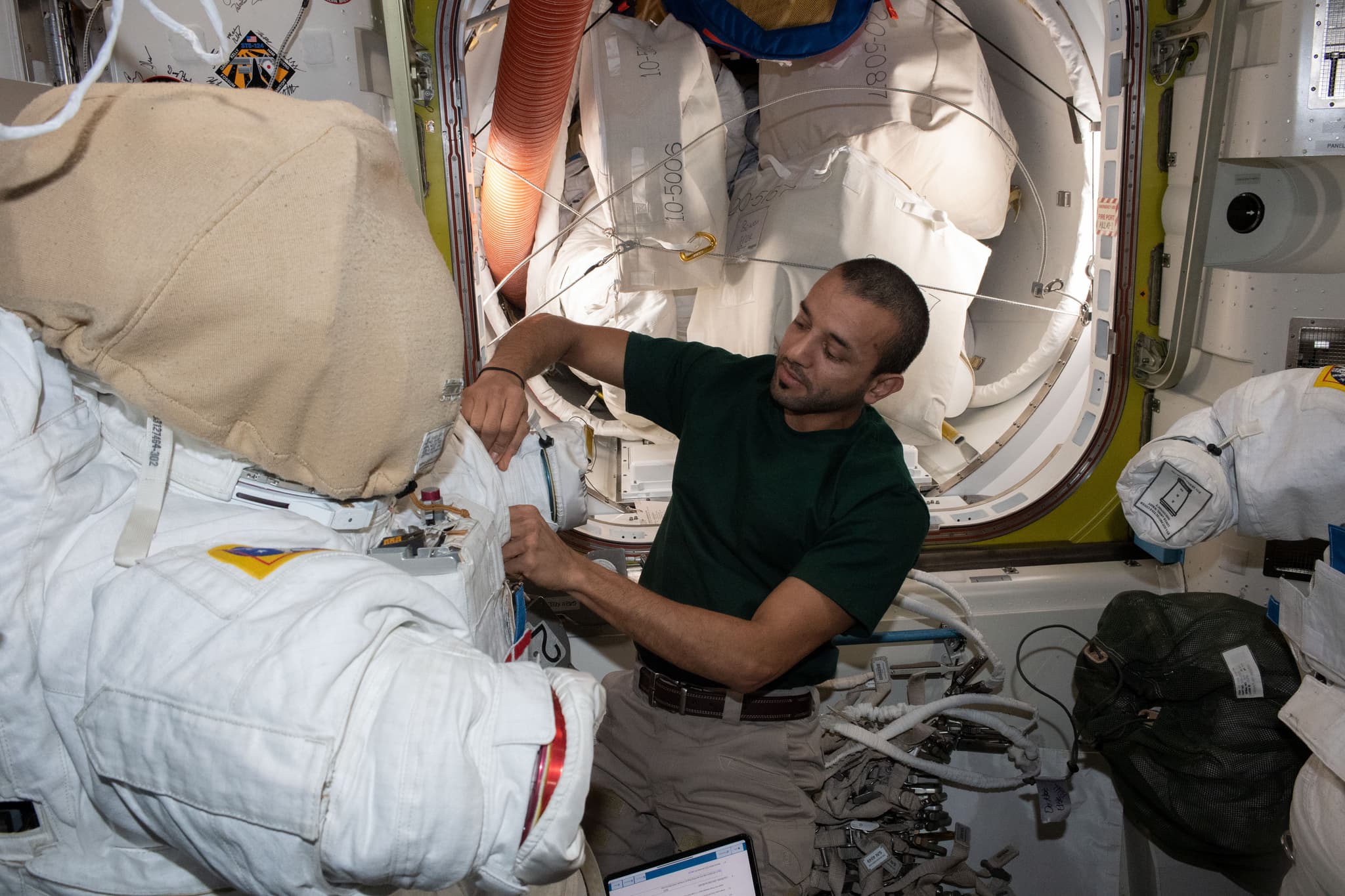 #2 UAE Astronaut Sultan Alneyadi Prepares Spacesuit in Quest Airlock — Humans in Space: The Most Iconic Spacewalk Photographs Ever Taken