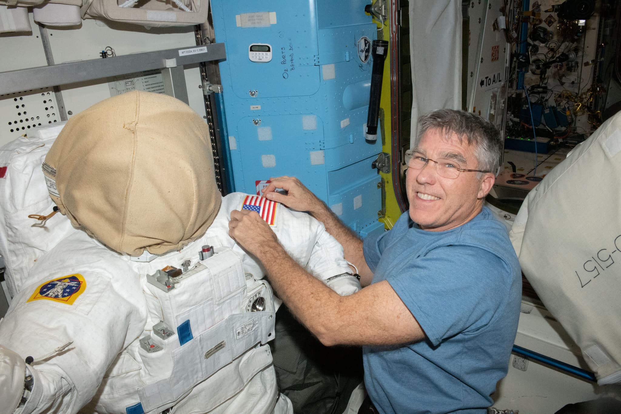 #3 NASA Astronaut Stephen Bowen Prepares Spacesuit — Quest Airlock — Humans in Space: The Most Iconic Spacewalk Photographs Ever Taken